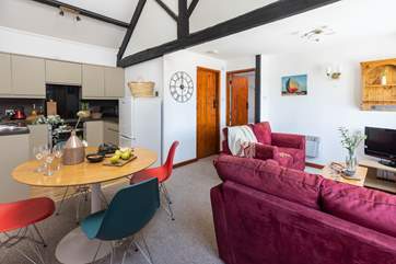 The open plan living area with double height ceilings and exposed beams.