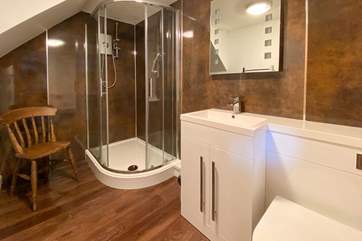 The en suite to bedroom one is modern and elegant.