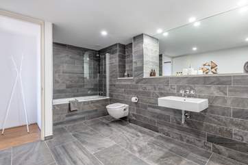 The amazing bathroom, off the main bedroom, with a shower over the bath.