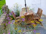 The outside terrace is prettily-planted with traditional cottage garden flowers.