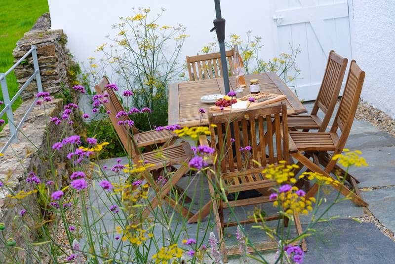 The outside terrace is prettily-planted with traditional cottage garden flowers.