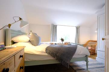 The super main bedroom is beautifully created in calming shades.