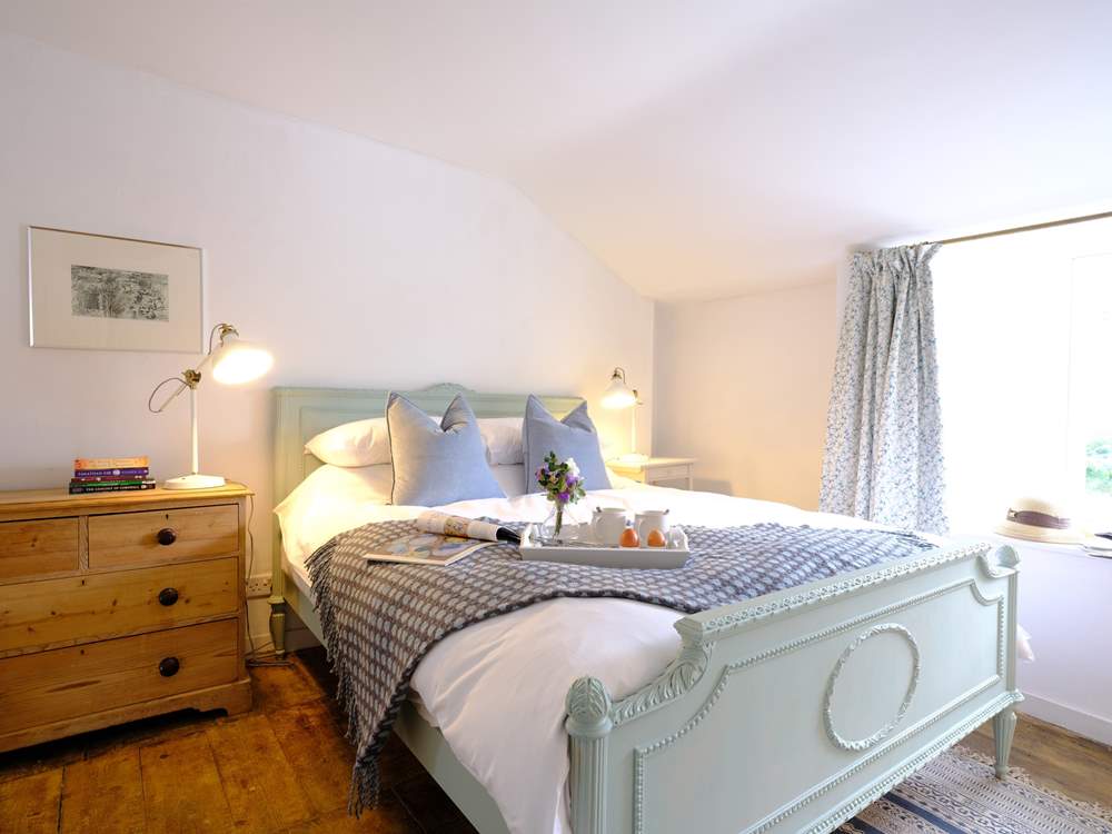 The characterful main bedroom with reclaimed wooden floors.