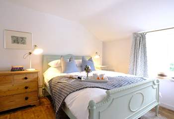 The characterful main bedroom with reclaimed wooden floors. 