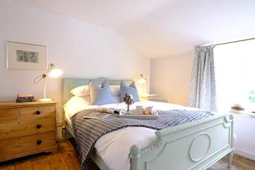 The characterful main bedroom with reclaimed wooden floors.