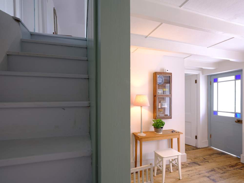 The steep cottage staircase to the first floor leads from the dining-room.