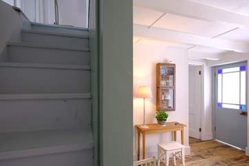 The steep cottage staircase to the first floor leads from the dining-room.