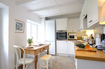 Natural light floods the well-equipped kitchen.