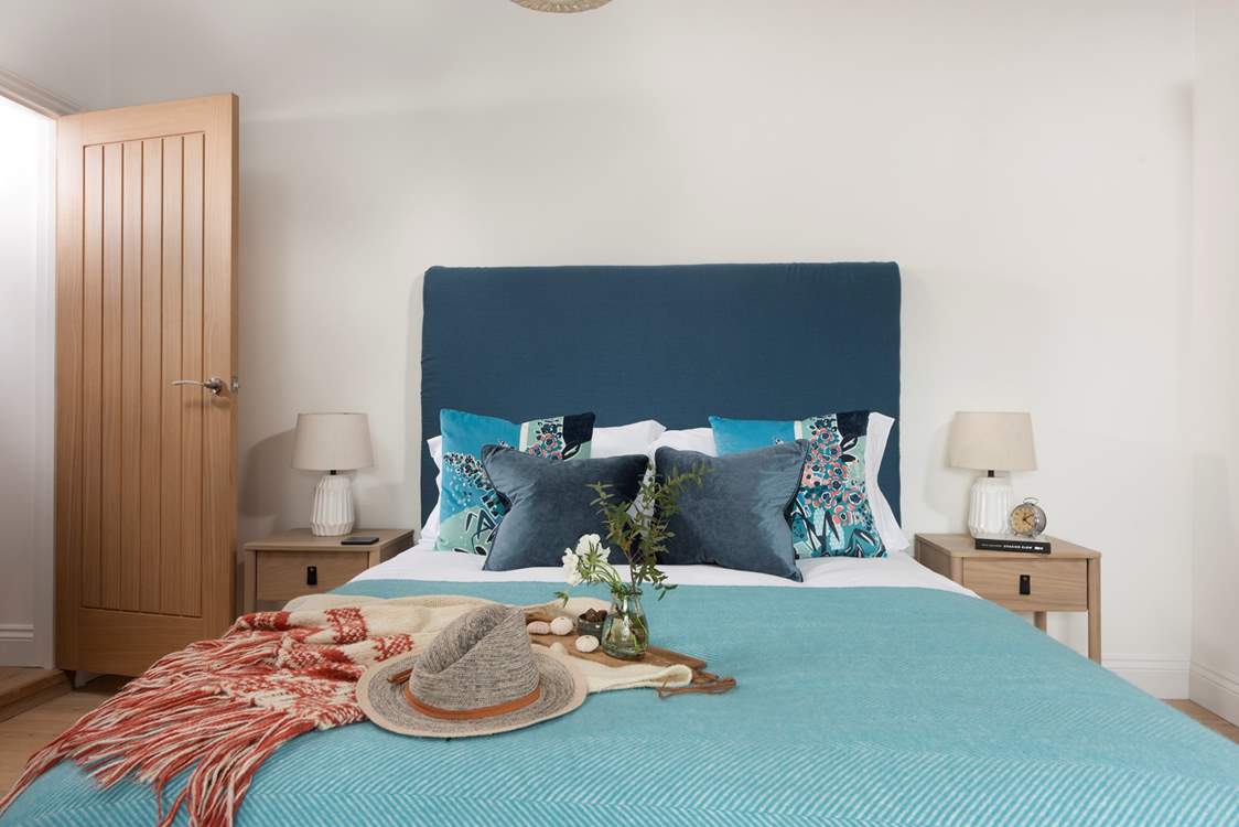 A lovely king-size bed awaits in bedroom 2.