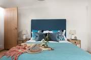 A lovely king-size bed awaits in bedroom 2.