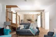 Soothing shades of blue and grey await you in the open plan sitting/dining-room.