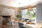 The dining-table takes pride of place in front of the picture window that leads out to the front garden.