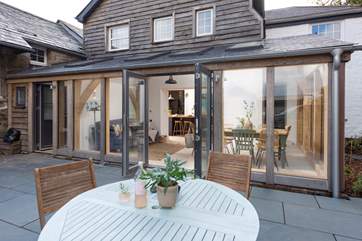 Double doors lead out from the sunroom to the back terrace, which catches the morning sun.