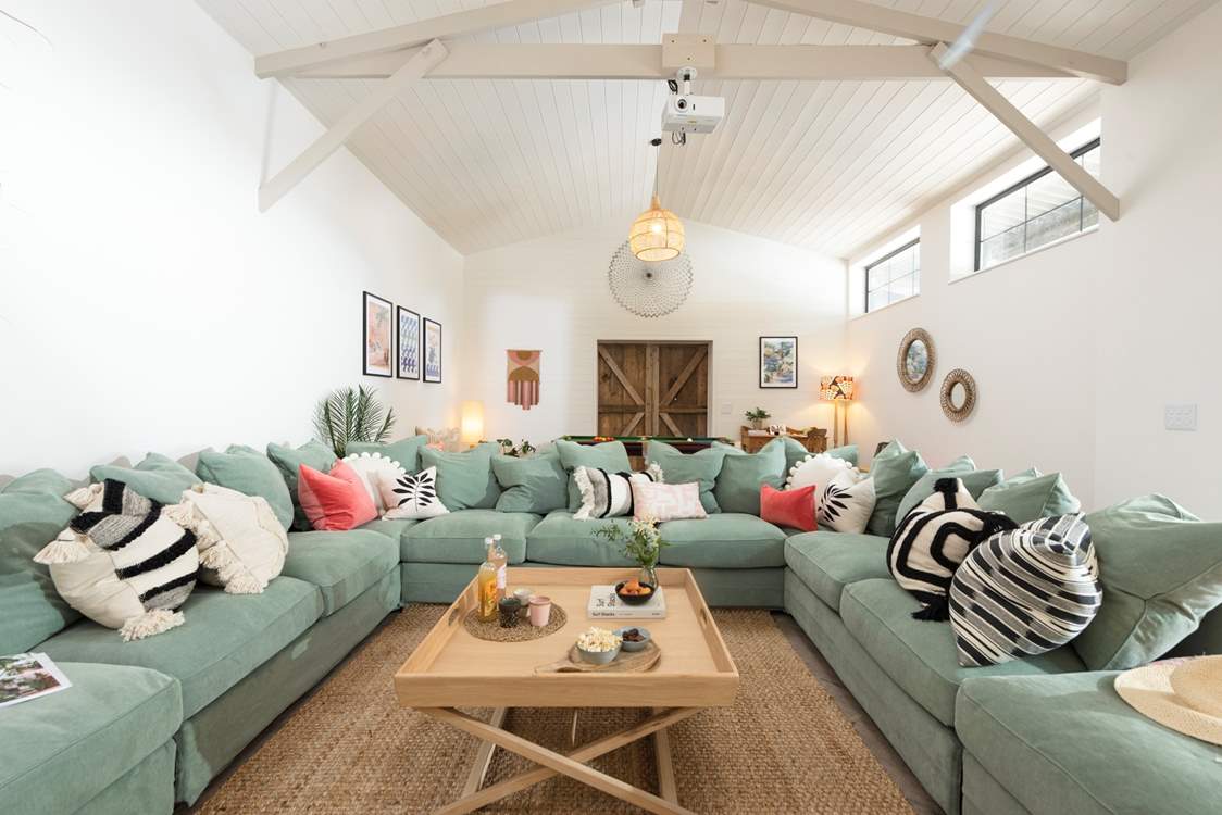 The huge sofa is large enough for all to snuggle up together.