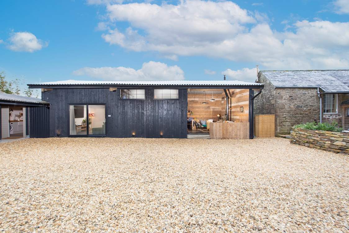 The cinema/games-room and bar area sit separate to the house. Moss Farmhouse also has oodles of space for parking.