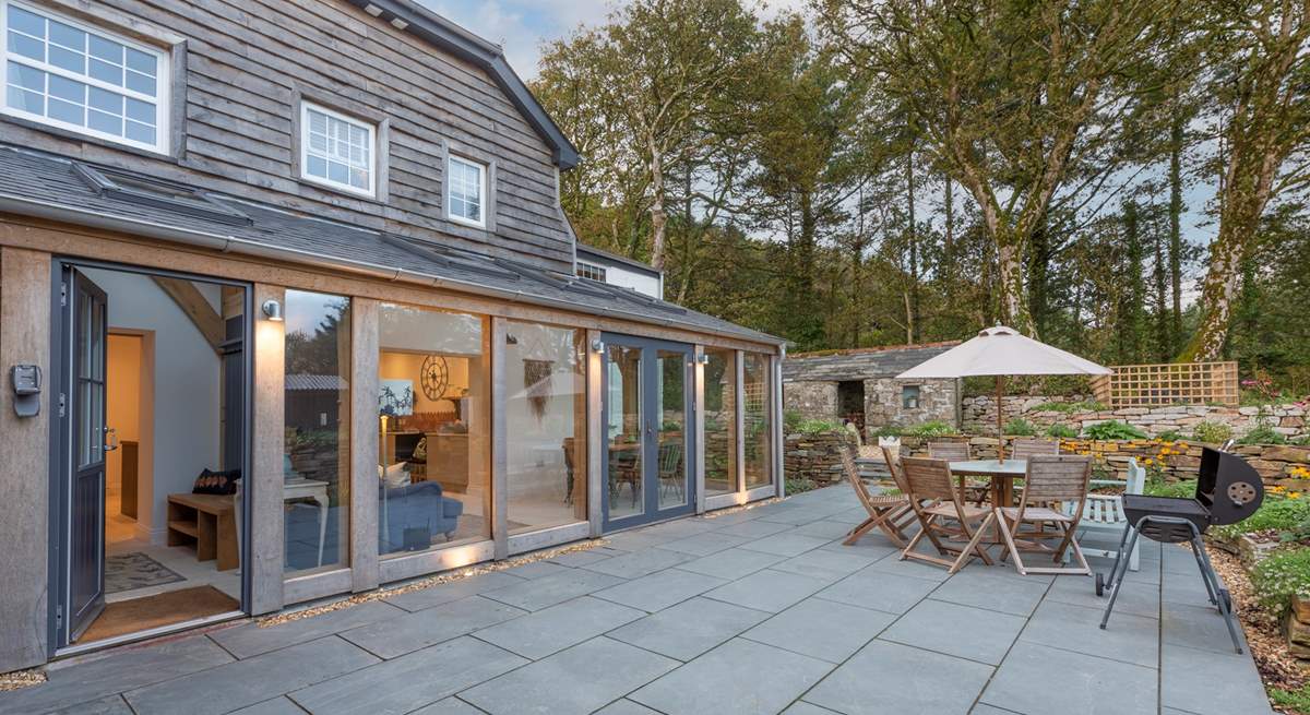 Double doors lead out from the sunroom to the back terrace, which catches the morning sun.