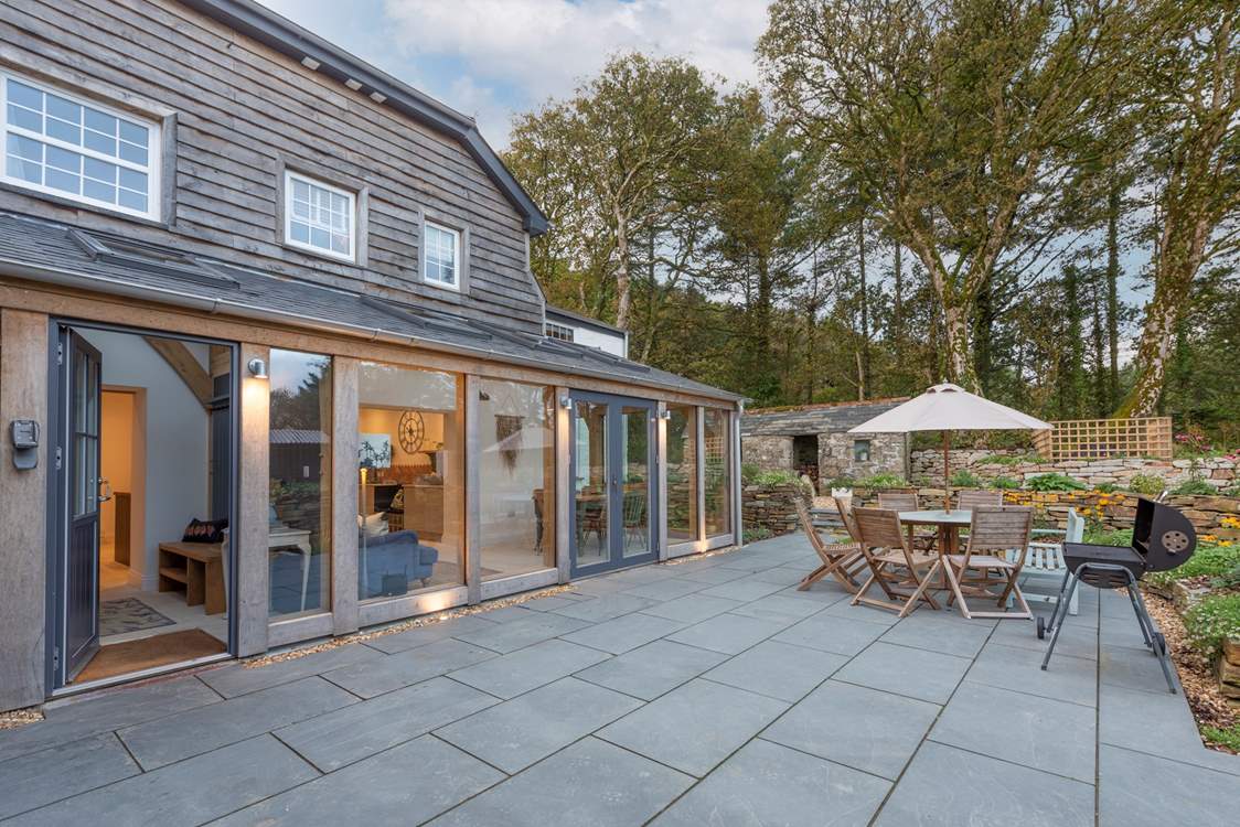 Double doors lead out from the sunroom to the back terrace, which catches the morning sun.
