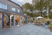 Double doors lead out from the sunroom to the back terrace, which catches the morning sun.