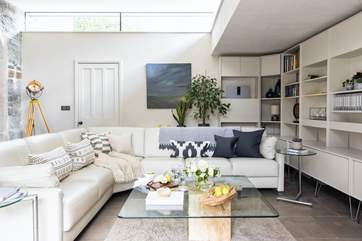 The light filled living-room has a super-comfy corner sofa and is a great place to relax.
