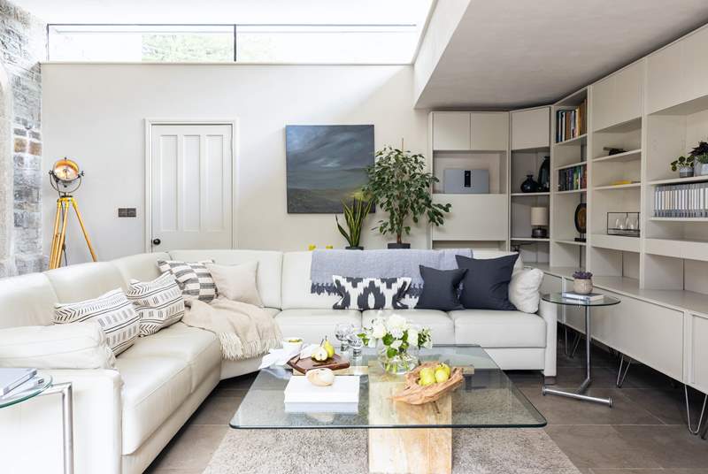 The light filled living-room has a super-comfy corner sofa and is a great place to relax.