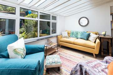 The sun-room is a lovely place to spend some time relaxing.