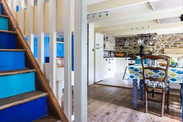 The original, steep staircase leads off the dining-area.