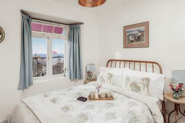 The very pretty main bedroom has a sea view.