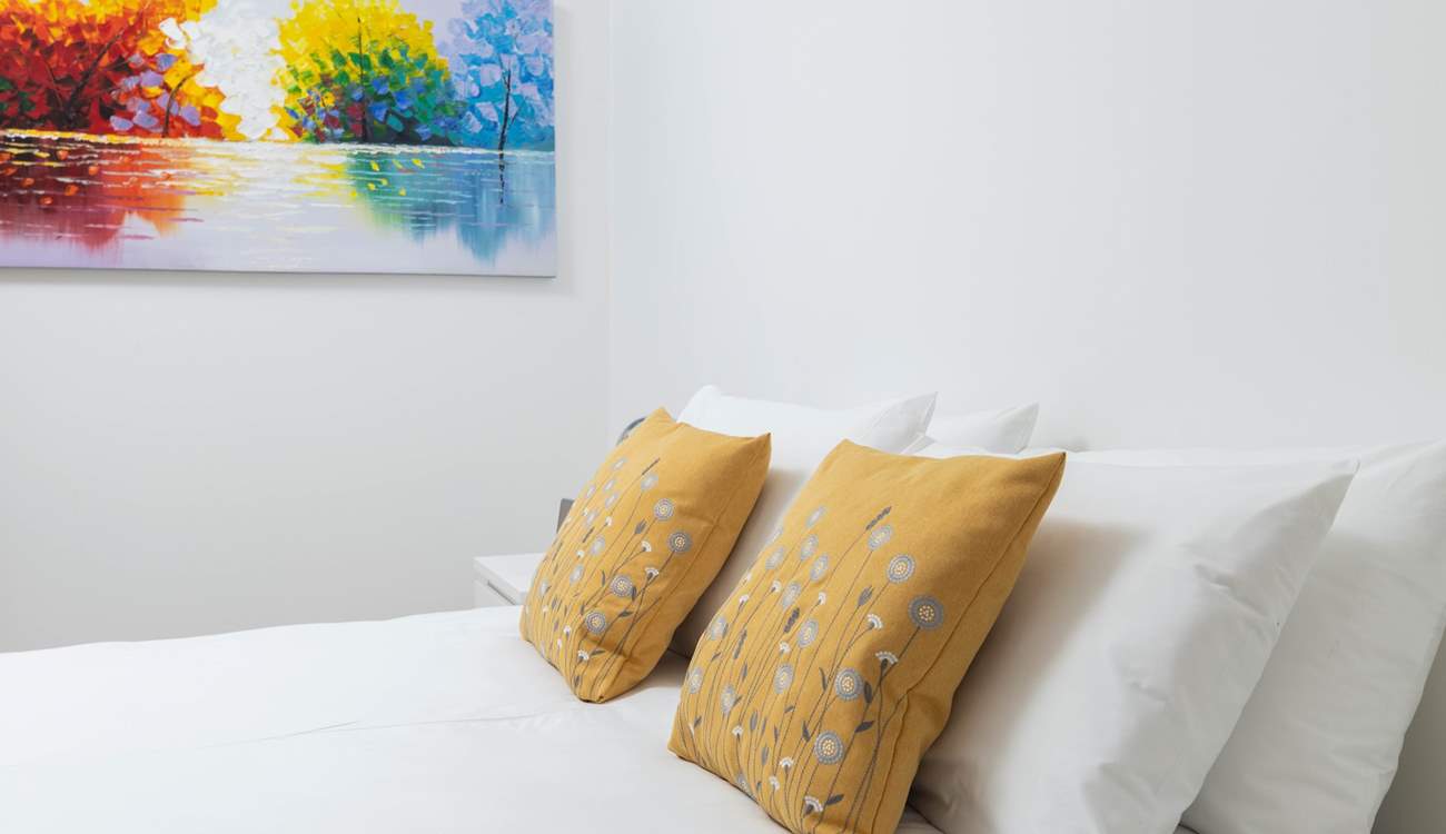 Pretty bedding adorns every bedroom.