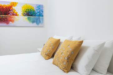 Pretty bedding adorns every bedroom.