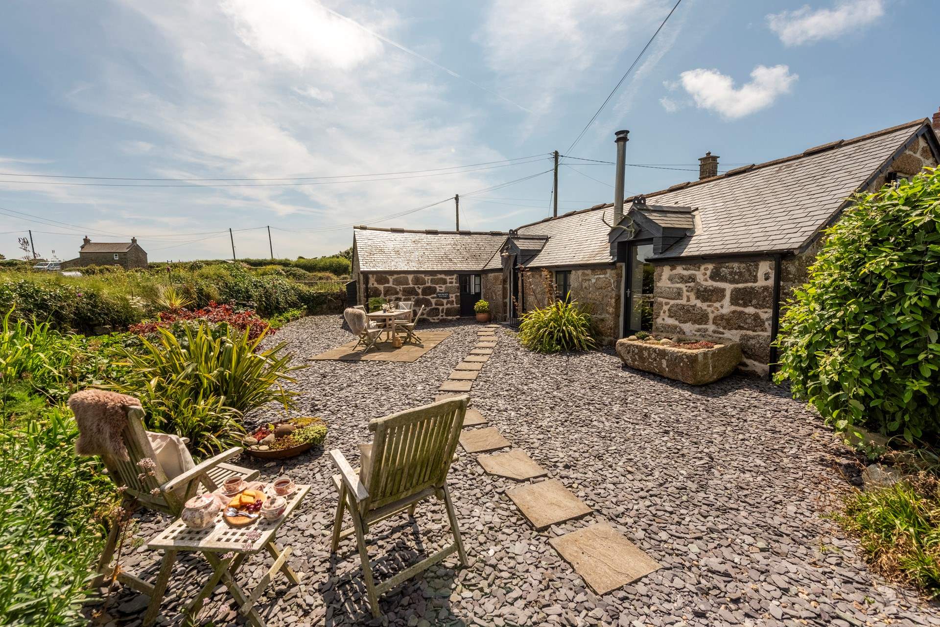Sheltered by an old Cornish hedge, the private patio area is perfect for al fresco dining.  