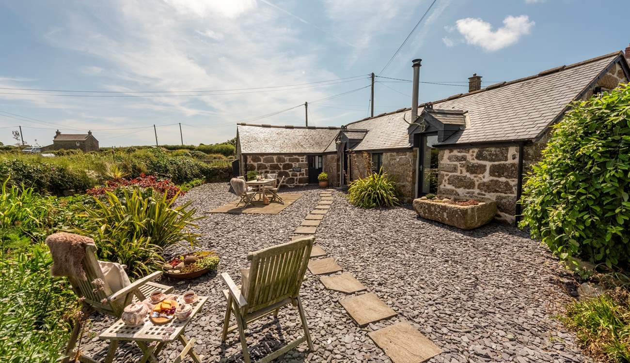 Sheltered by an old Cornish hedge, the private patio area is perfect for al fresco dining.  