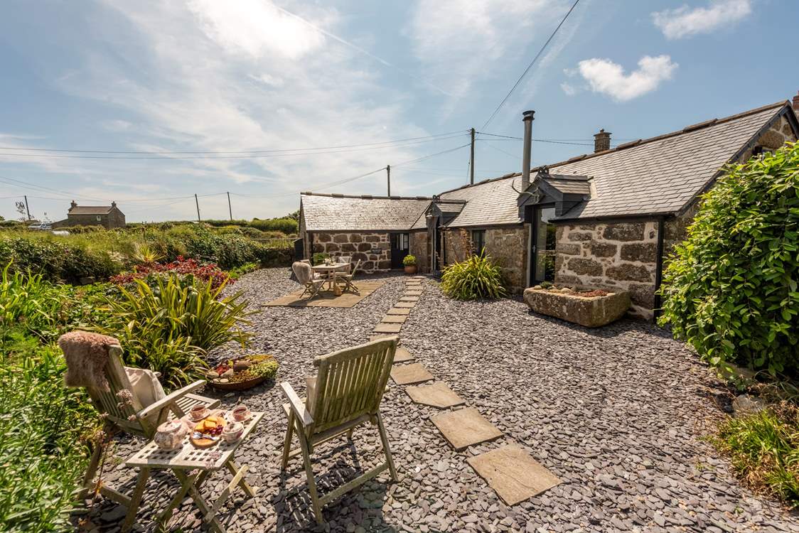 Sheltered by an old Cornish hedge, the private patio area is perfect for al fresco dining.