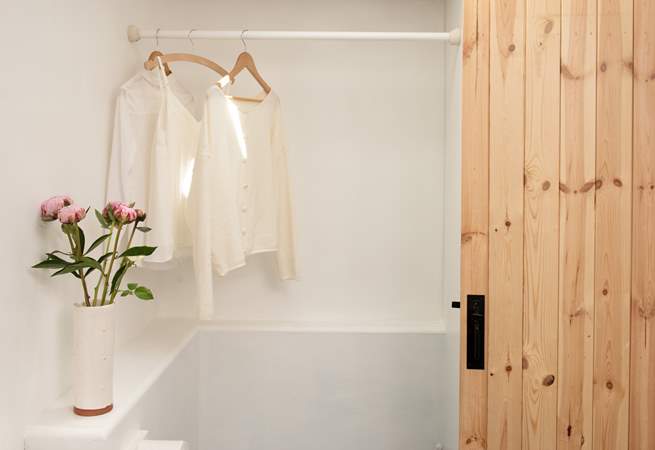 There is plenty of hanging space in the shower-room.