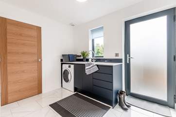 The utility-room downstairs with a washing machine, shower-room and access to outdoors.
