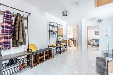 The hallway leading to the kitchen and living areas, and the utility-room and downstairs shower-room.