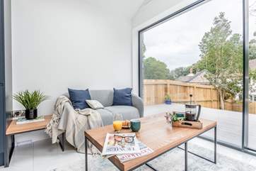 This comfy little sofa flooded in light is perfect for reading your book.