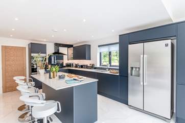 This modern and spacious kitchen is heaven for those that love to cook and has a large American fridge/freezer.