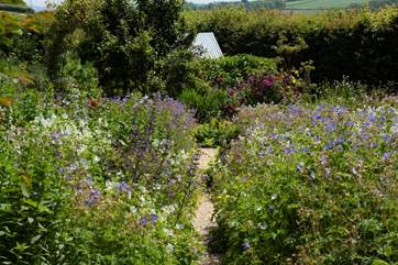 Sweeps of colour flow through the country-style garden which you can access through the cast iron gate.