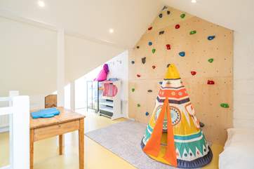 The children's bedroom on the second floor has a fabulous climbing wall and games, a child's dream room!