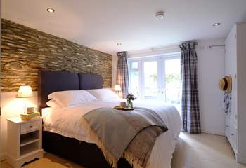 The beautifully furnished en suite main bedroom has direct access to the patio, ideal for your morning coffee.