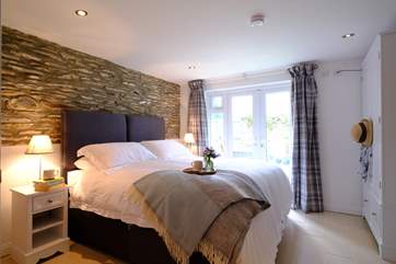 The beautifully furnished en suite main bedroom has direct access to the patio, ideal for your morning coffee.