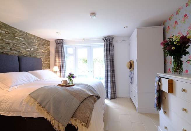 The main bedroom is a delight, with fabulous luxury bed linens and patio doors to the outside space.