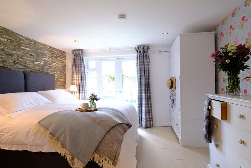 The main bedroom is a delight, with fabulous luxury bed linens and patio doors to the outside space.