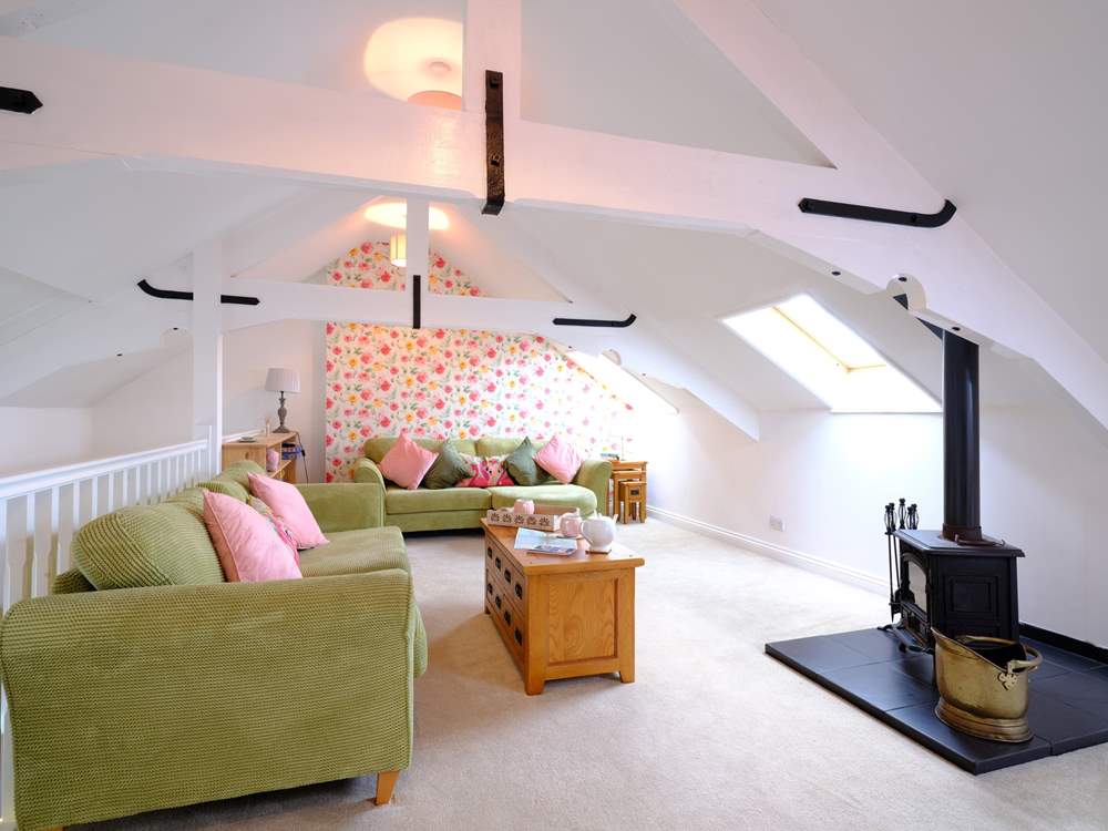 This wonderful property is reverse level to make the most of the space, so this fabulous sitting-room is on the top level above the kitchen/diner with the bedrooms on the lower ground floor.