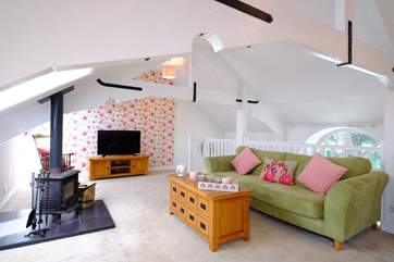 This light-filled room on the top floor has a wood-burner making this the ideal place for holidays all year round.