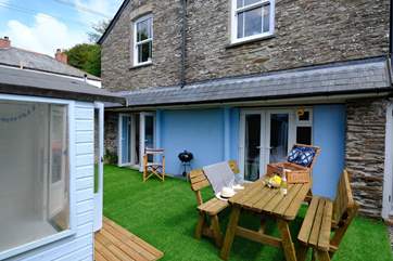 The outside space is the perfect chill out zone with summer-house, pine garden furniture and the all important barbecue.