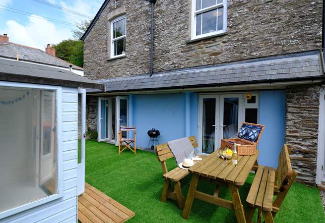 The outside space is the perfect chill out zone with summer-house, pine garden furniture and the all important barbecue.