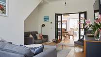 The lovely living area leading to the dining-room and kitchen.
