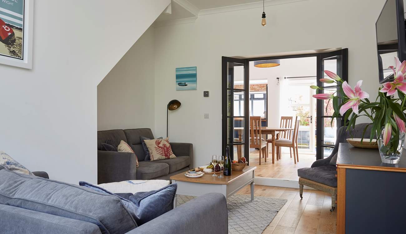 The lovely living area leading to the dining-room and kitchen.