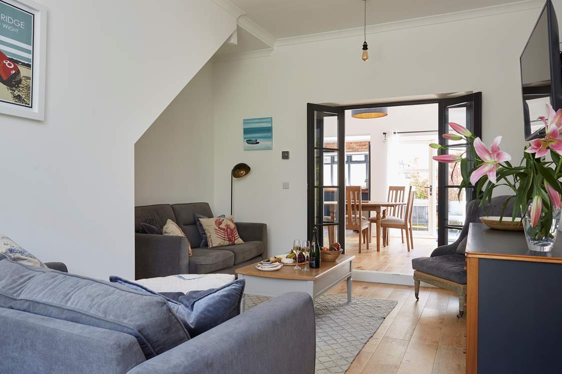 The lovely living area leading to the dining-room and kitchen.